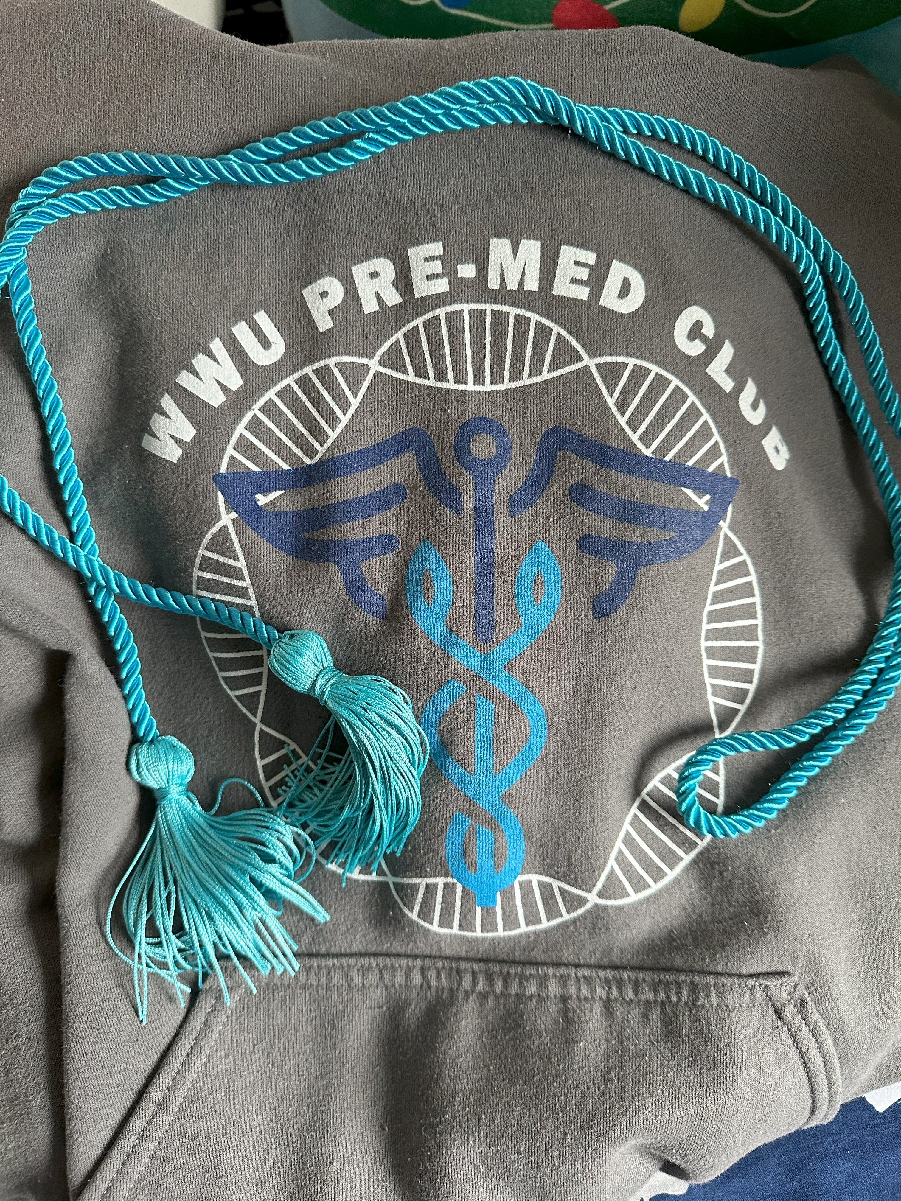 Teal blue cord and WWU Pre-Med Club sweatshirt
