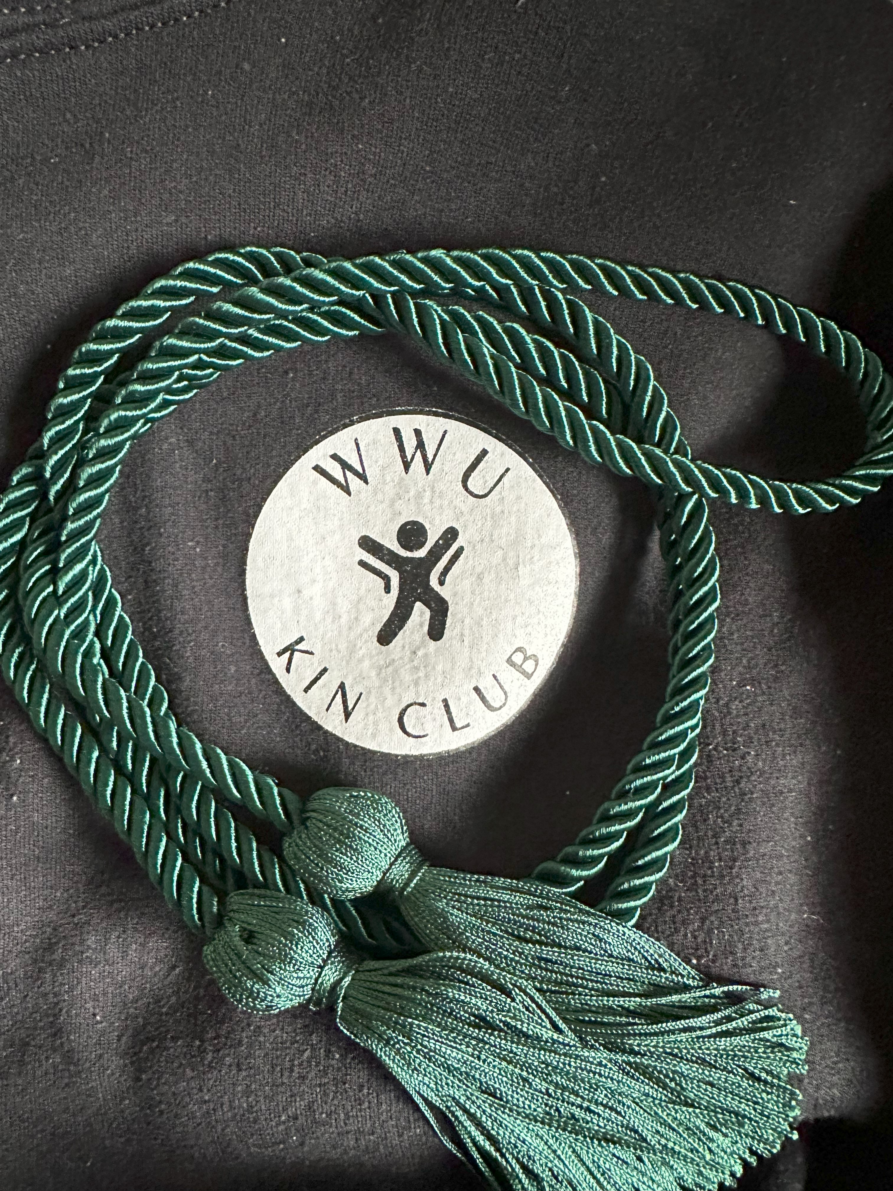 Dark green cord and WWU Kin Club sweatshirt