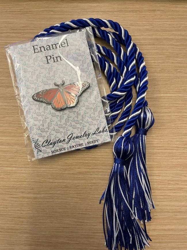 BRC blue cord with enamel pin in package.